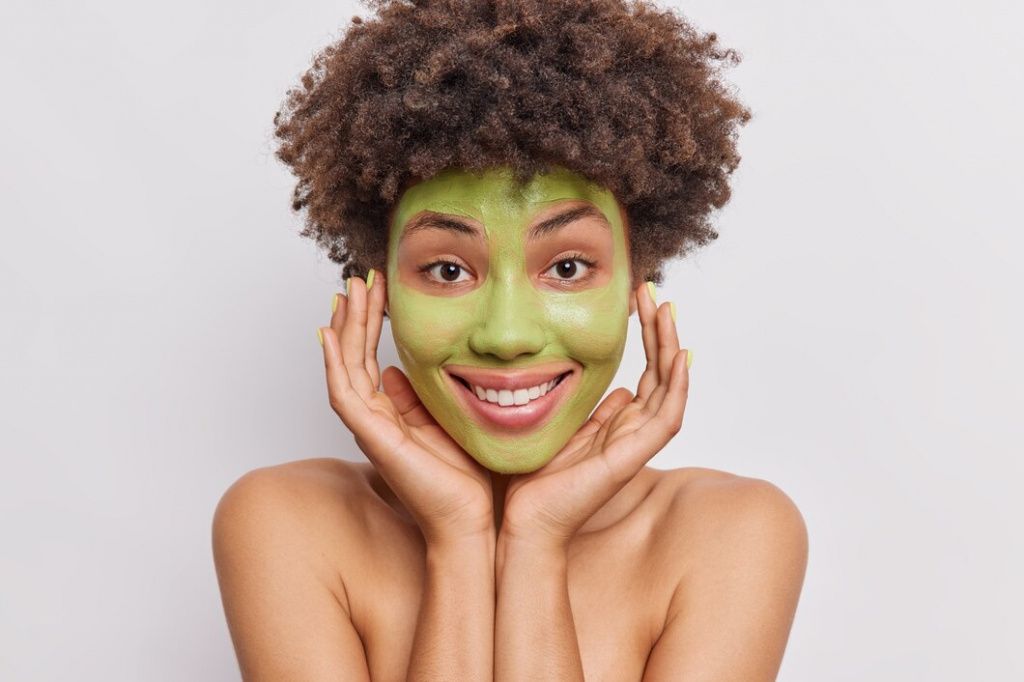 woman-keeps-hand-face-applies-green-cucumber-mask-skin-nourishing-poses-topless-white_273609-52528.jpg